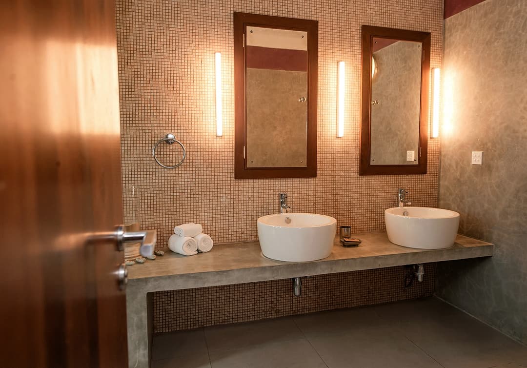 Bathroom with twin vanity and warm natural tones at Cottage Kabalana, Ahangama, Sri Lanka