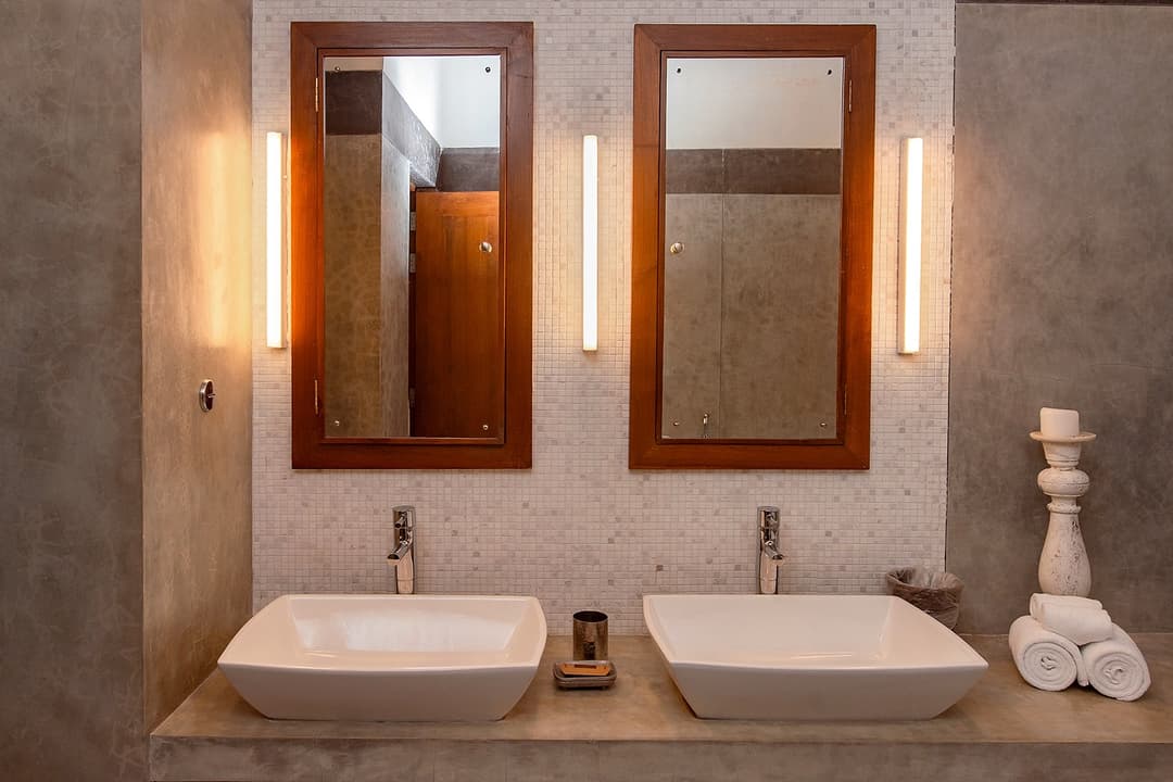 Twin vanity bathroom with warm amber lighting at Cottage Kabalana, Ahangama, Sri Lanka