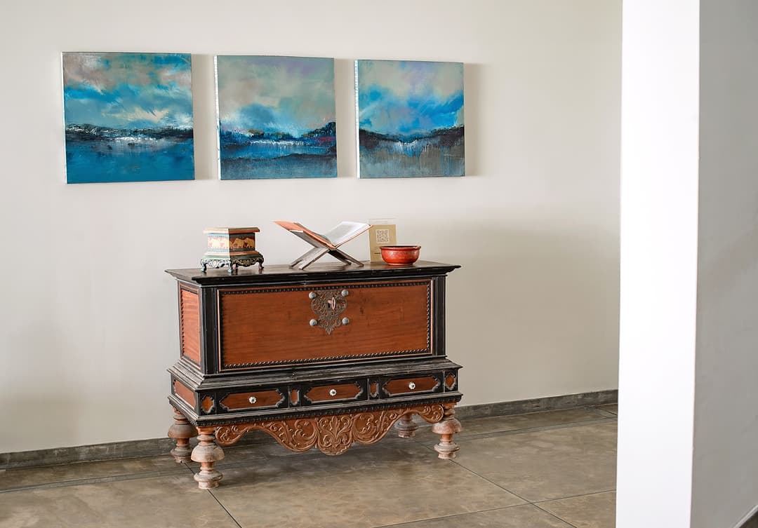 Antique sideboard with ocean paintings at Cottage Kabalana, Ahangama, Koggala, Sri Lanka