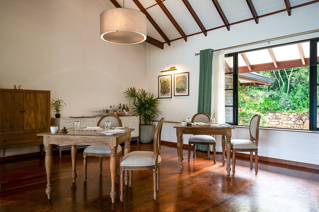 Indoor dining room with timber floors and garden views at Camellia Hills, Dickoya