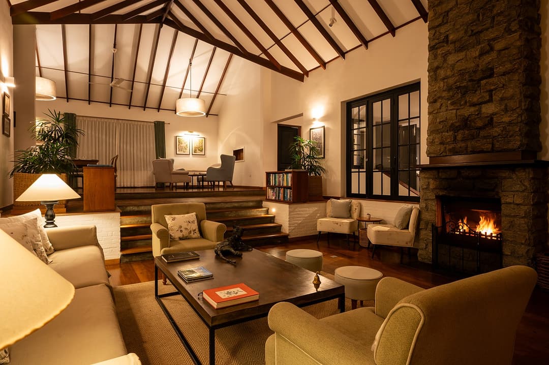 Warm lounge interior with stone fireplace at Camellia Hills, Dickoya, Sri Lanka