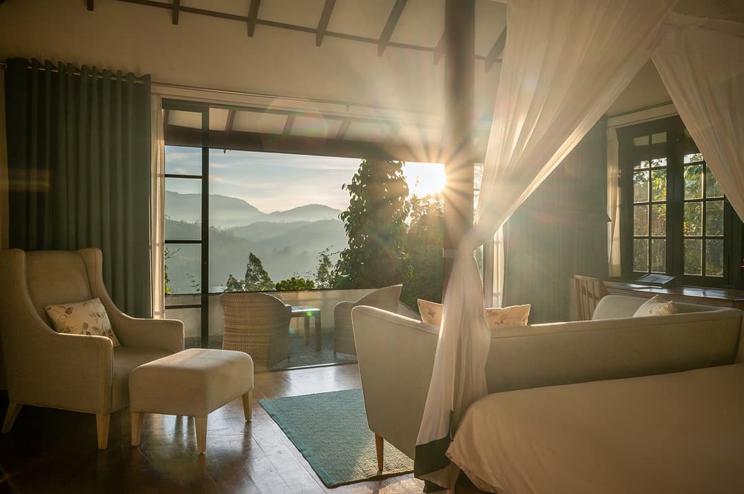 Dickoya suite bedroom with mountain sunlight and wicker chairs, Camellia Hills