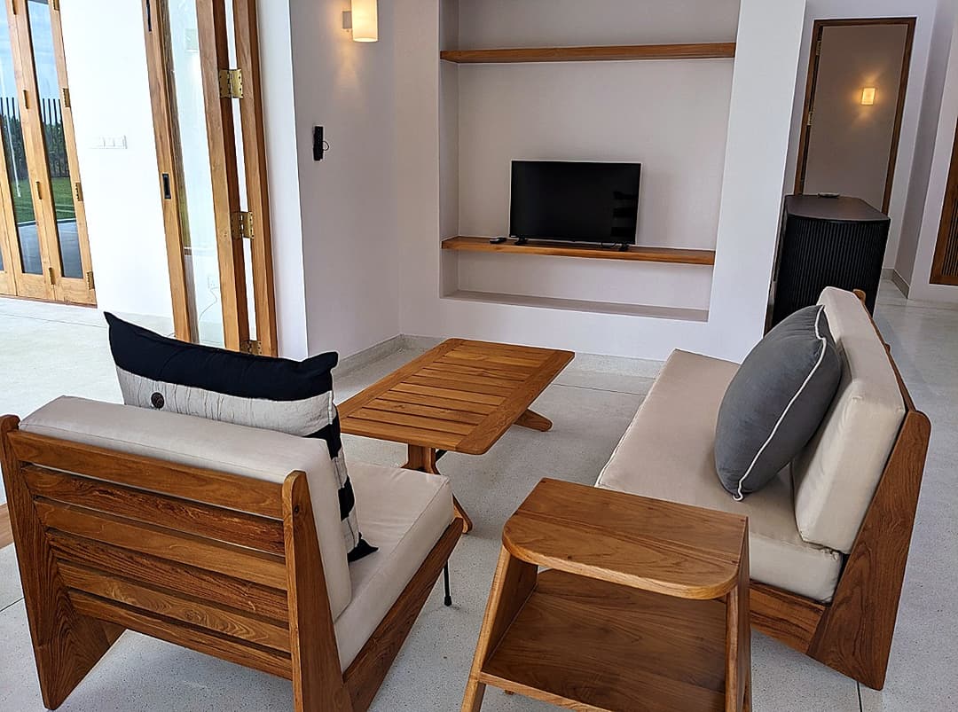 Living room with sofa and TV at Salt and Stone, Ahangama, Koggala, Sri Lanka