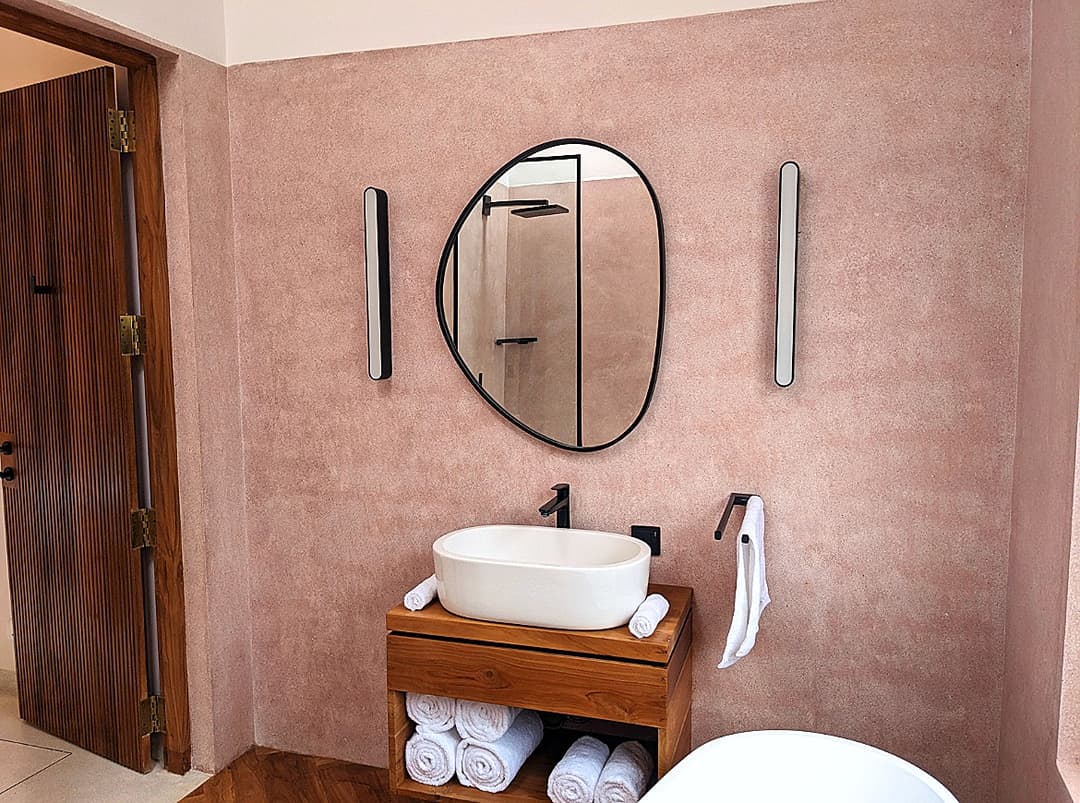 Pink bathroom vanity with oval mirror at Salt and Stone, Ahangama, Koggala, Sri Lanka