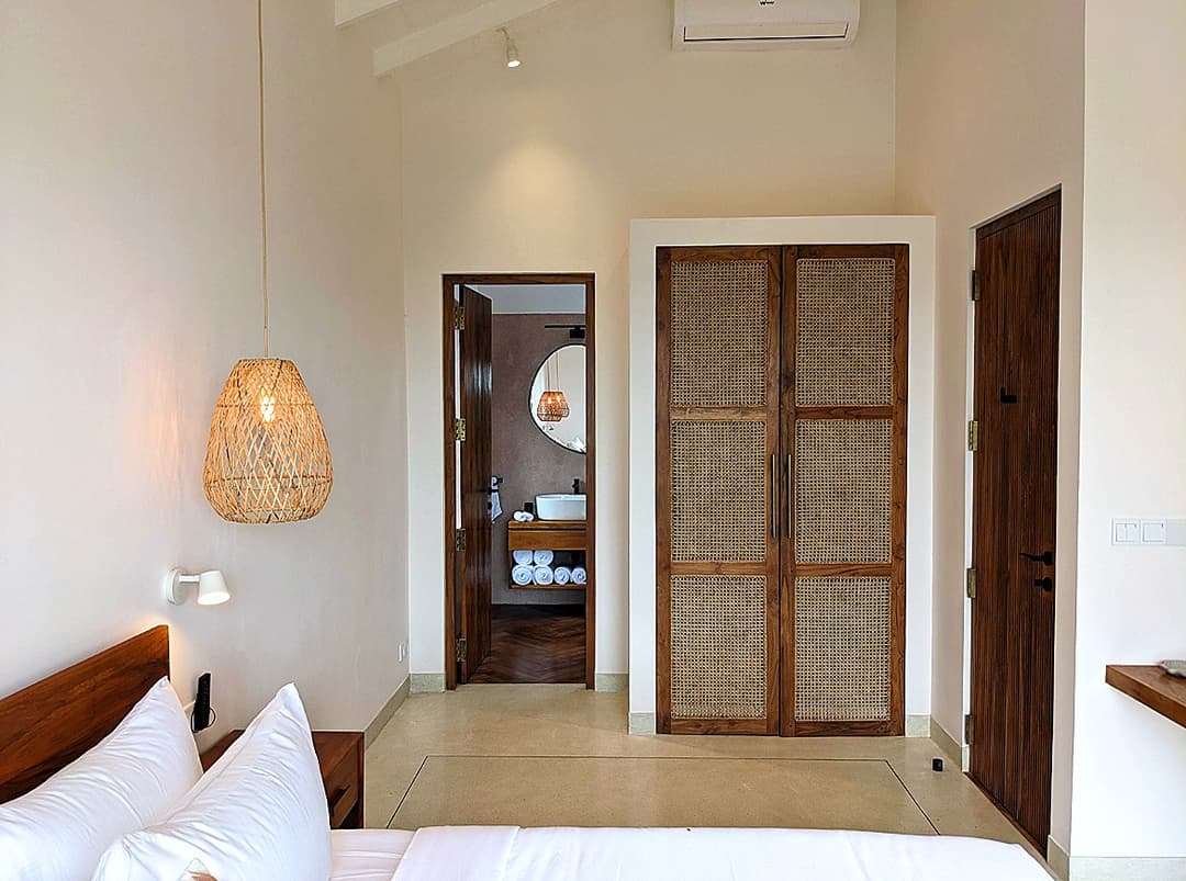 Bedroom entrance corridor with rattan lamp at Salt and Stone, Ahangama, Sri Lanka