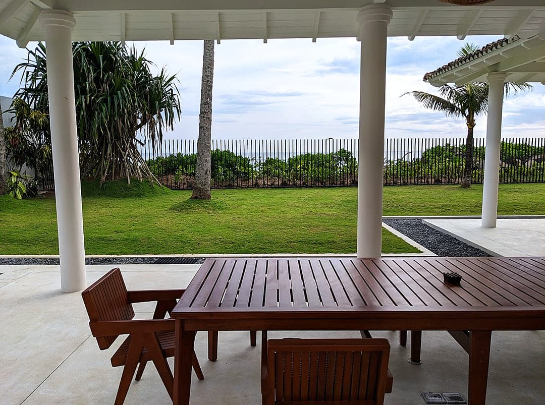 Outdoor dining terrace with garden and Indian Ocean beyond at Salt and Stone, Ahangama
