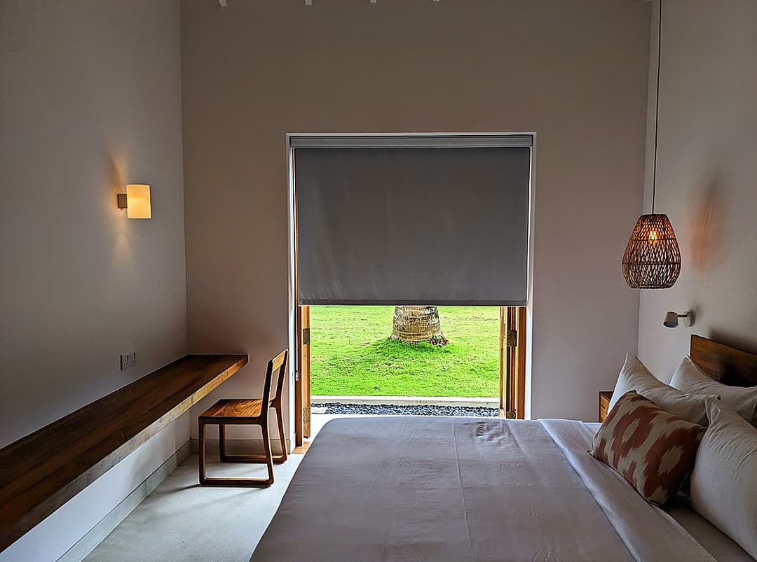 Bedroom with roller blind and tropical garden view at Salt and Stone, Ahangama