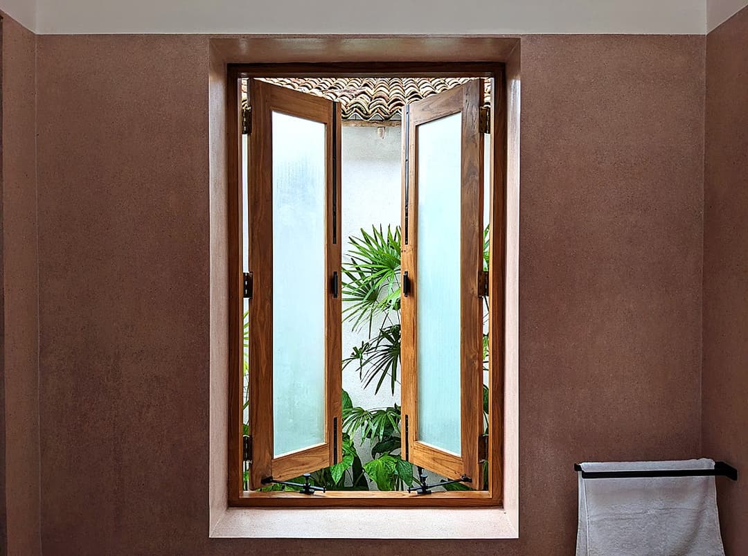 Bathroom with timber window shutters and tropical planting, Salt and Stone, Ahangama