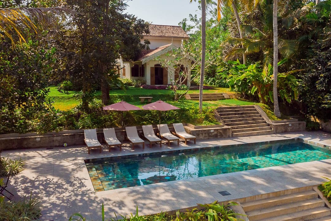Aerial side angle of Island Villa Ahangama pool in tropical garden, Ahangama, Sri Lanka