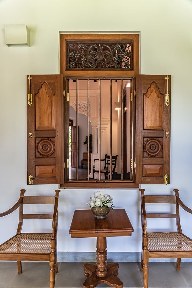 Antique carved windows with decorative panel in entrance hall at Island Villa Ahangama