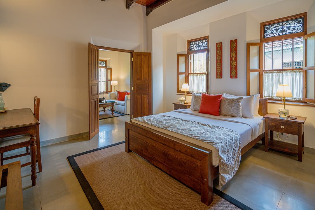 Bedroom with king bed and red accent cushion at Island Villa Ahangama, Ahangama, Sri Lanka