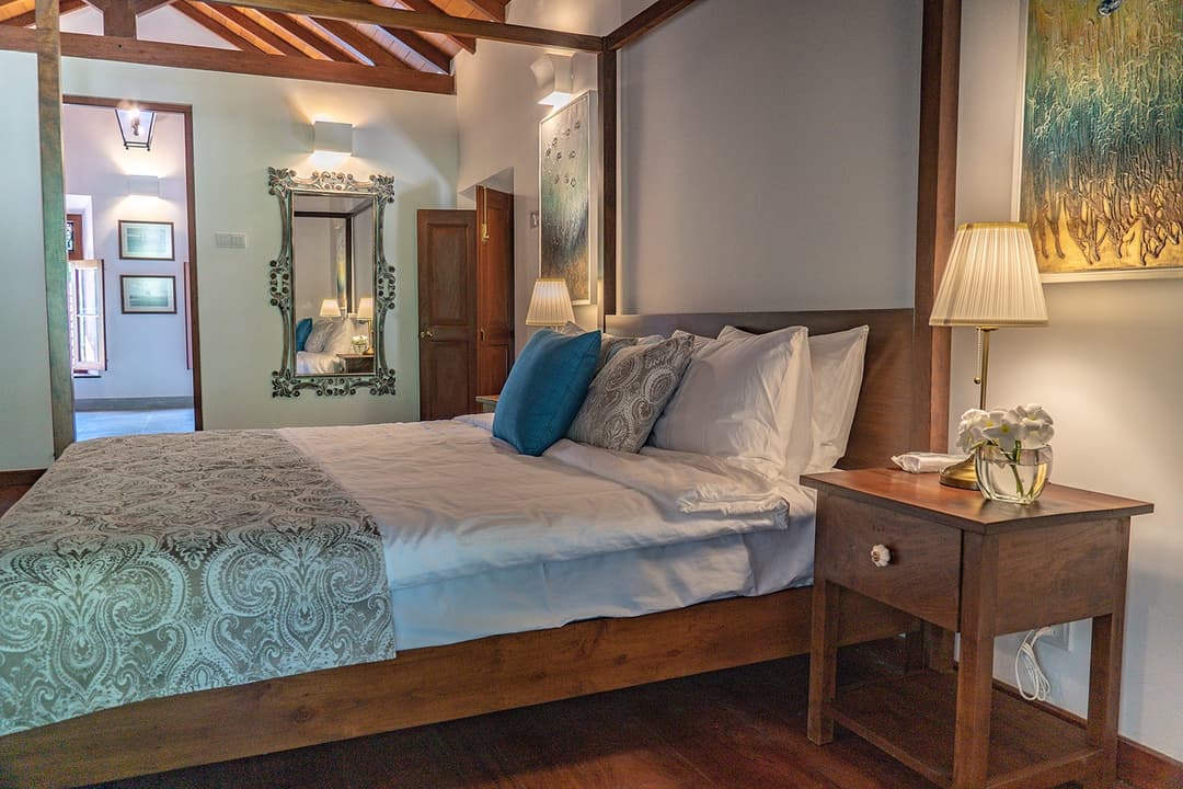 King bedroom with teal cushions at Island Villa Ahangama, Ahangama, Sri Lanka