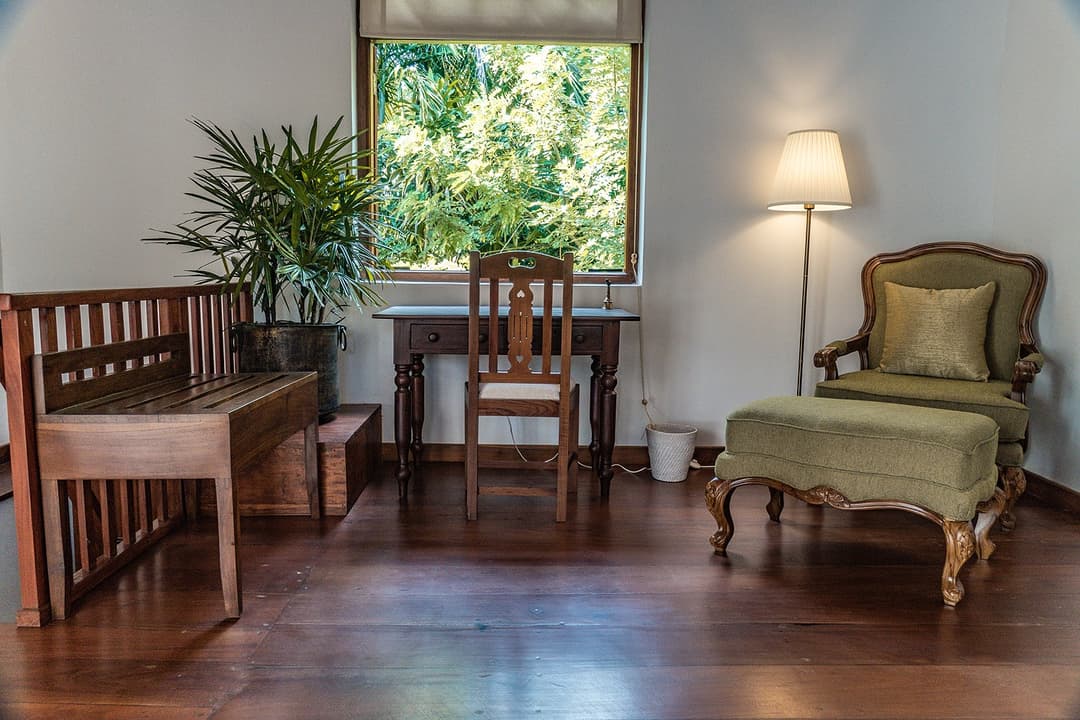 Bedroom study with armchair and garden window at Island Villa Ahangama, Ahangama, Sri Lanka