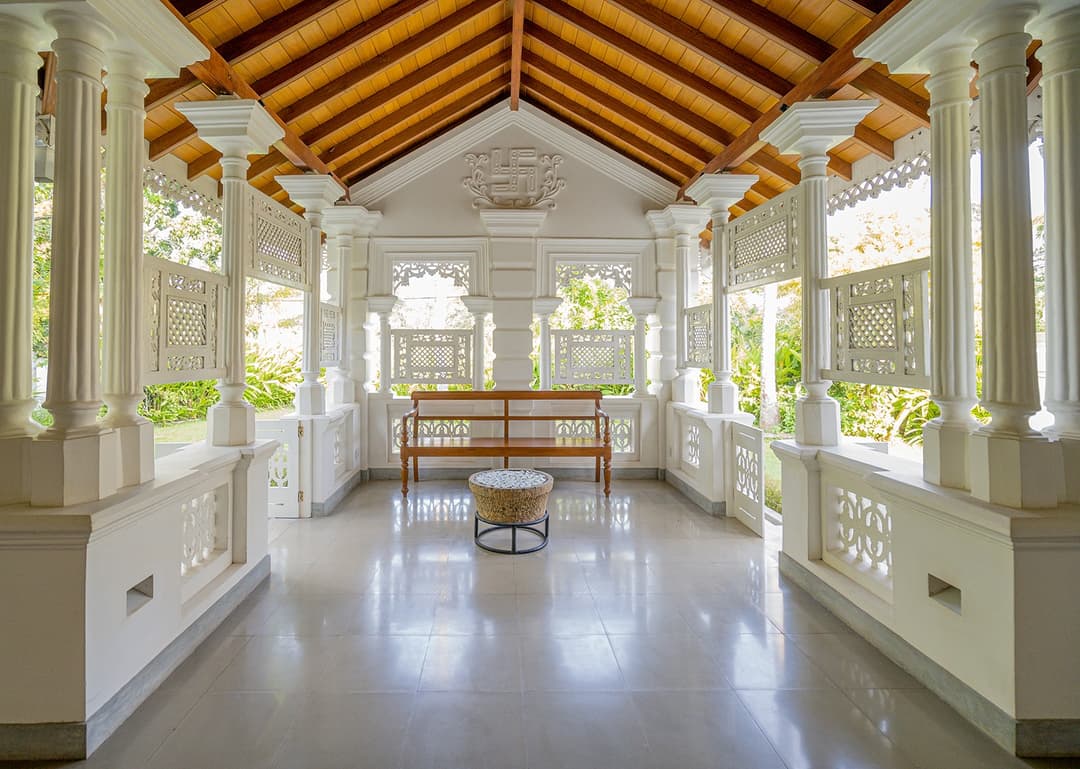 Colonnaded hall with white columns and bench at Island Villa Ahangama, Ahangama, Sri Lanka