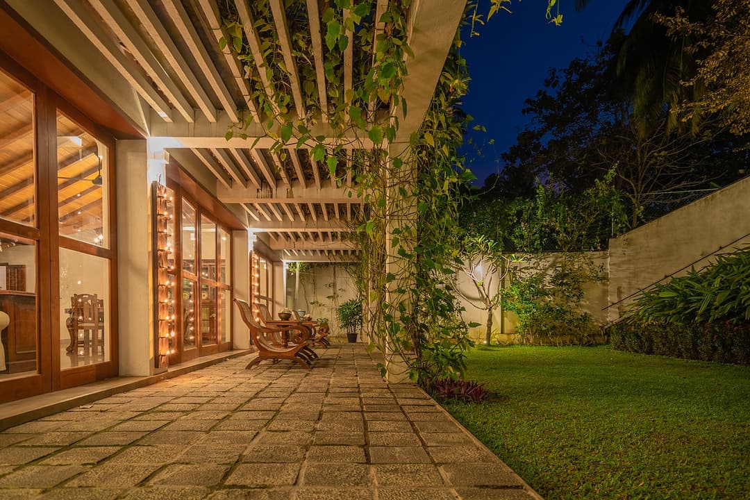 Covered walkway and veranda lit at evening at Island Villa Ahangama, Ahangama, Sri Lanka