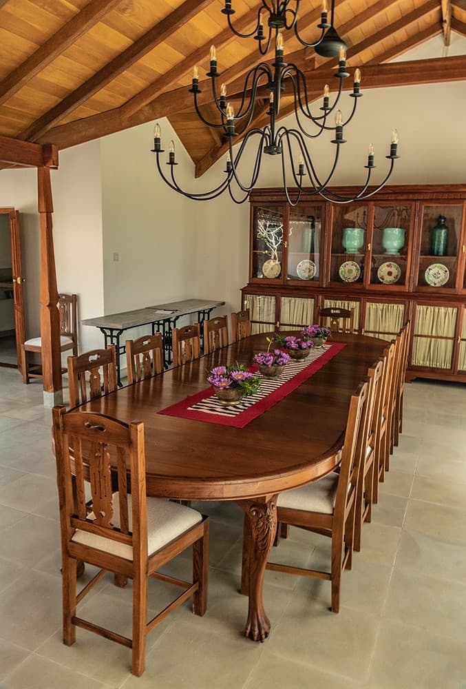 Dining room with long timber table and chandelier at Island Villa Ahangama, Ahangama