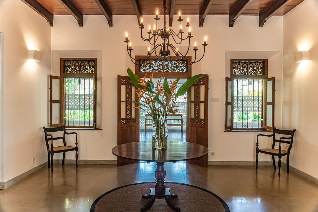 Entrance hall with stained glass windows and chandelier at Island Villa Ahangama