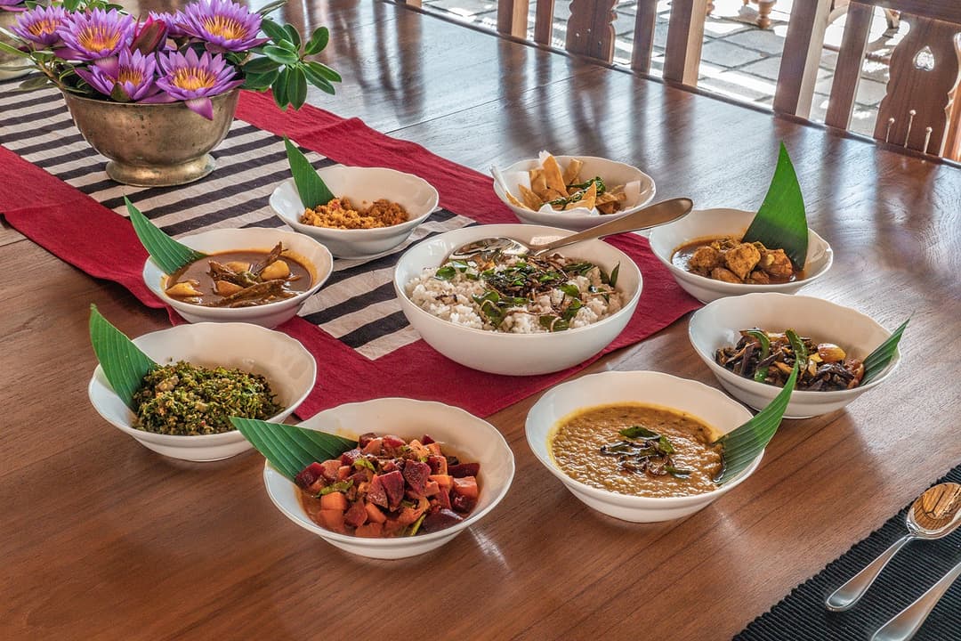 Sri Lankan rice and curry spread on dining table at Island Villa Ahangama, Ahangama