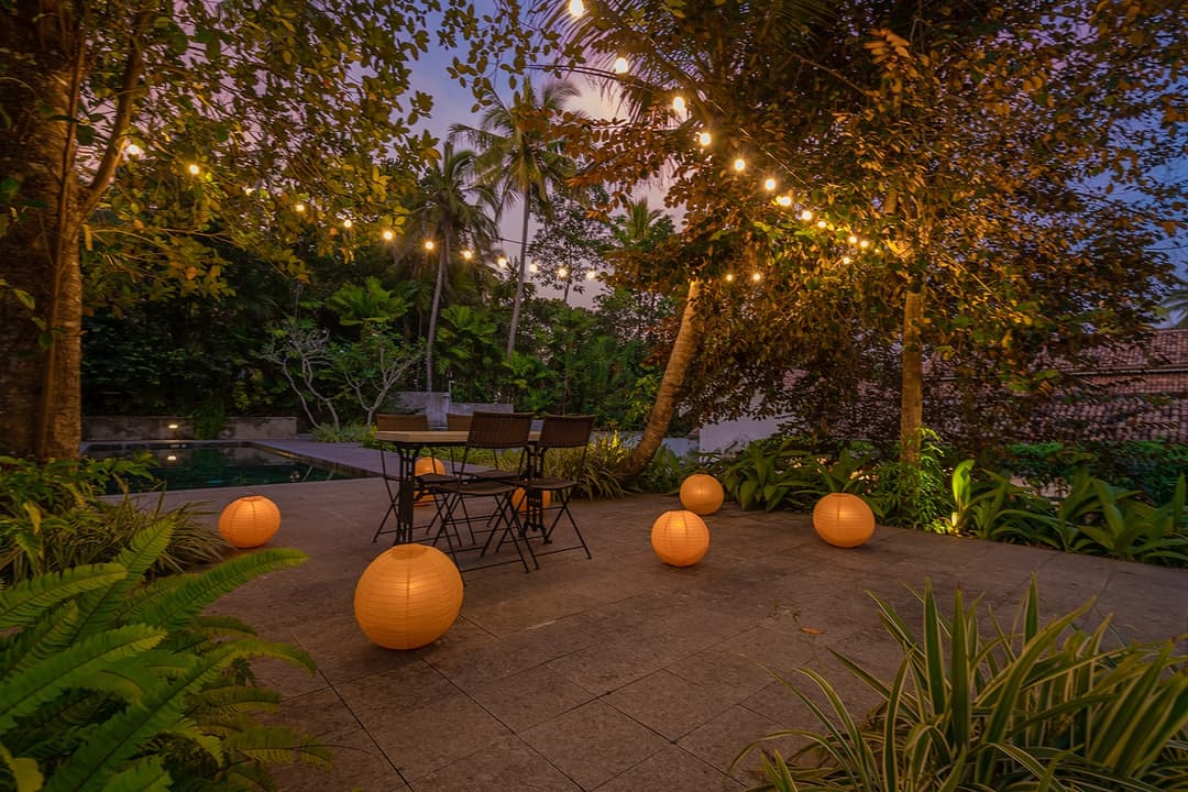 Garden illuminated with string lights and lanterns at Island Villa Ahangama, Ahangama