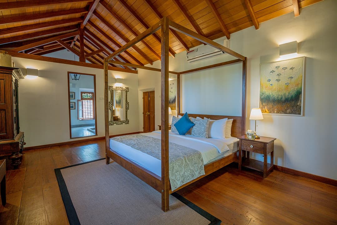 Garden house bedroom with four-poster canopy bed at Island Villa Ahangama, Ahangama