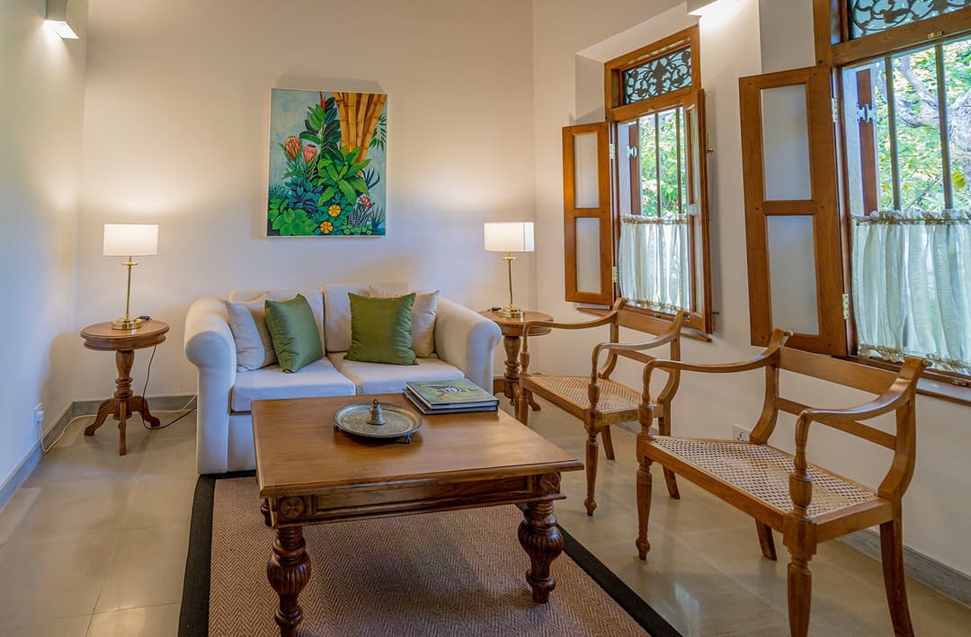 Garden house bedroom with sitting room sofas at Island Villa Ahangama, Ahangama, Sri Lanka