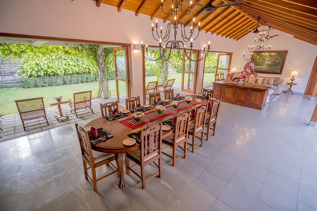 Garden house dining table with chandelier and garden view at Island Villa Ahangama