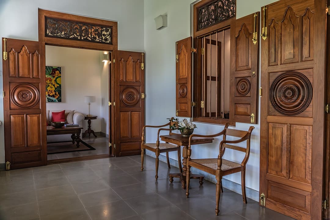 Interior carved timber door with decorative circular panel at Island Villa Ahangama