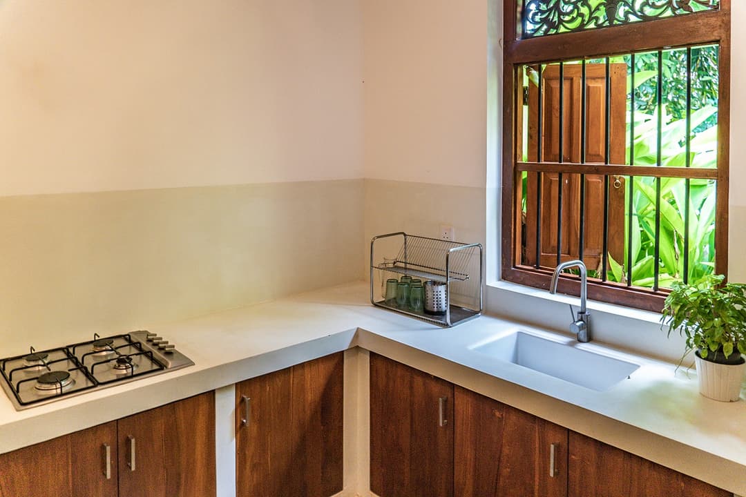 Kitchen with timber counter and hob at Island Villa Ahangama, Ahangama, Sri Lanka