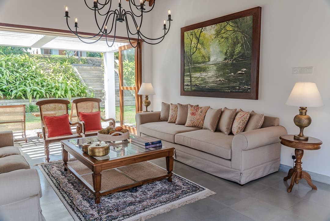 Lounge with cream sofas, chandelier and garden view at Island Villa Ahangama, Ahangama