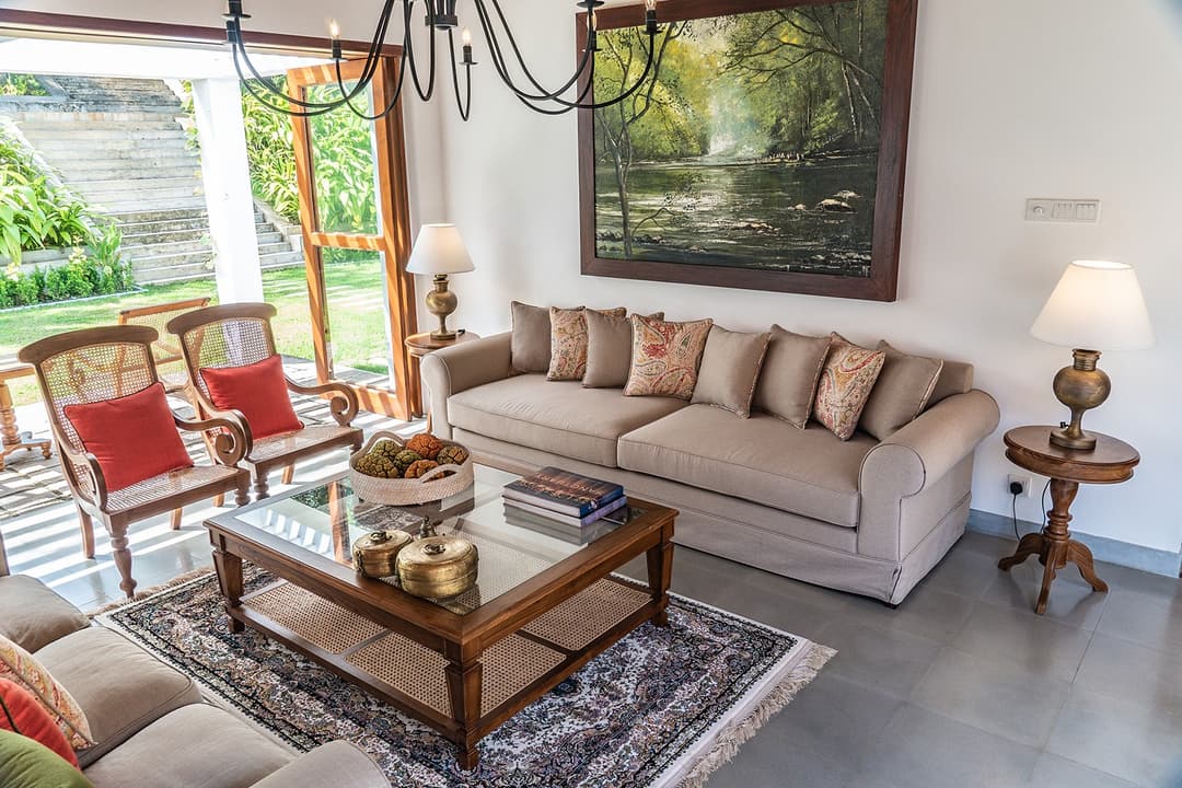 Lounge with cream sofa and large landscape painting at Island Villa Ahangama, Ahangama