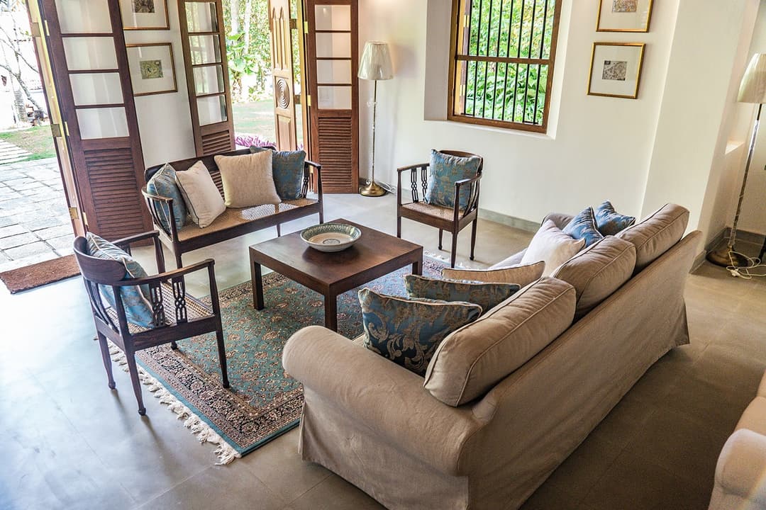 Lounge with sofas and colonial armchairs at Island Villa Ahangama, Ahangama, Sri Lanka