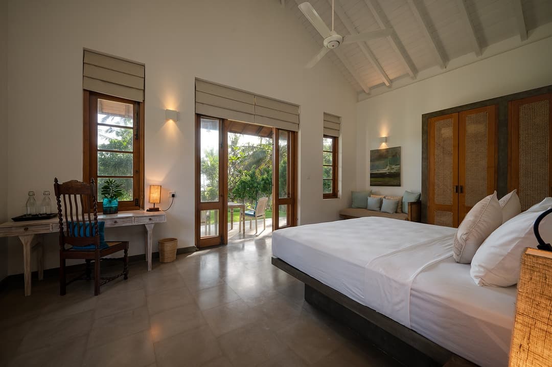 King bedroom in afternoon light with garden doors open at Kirana Villa, Bentota
