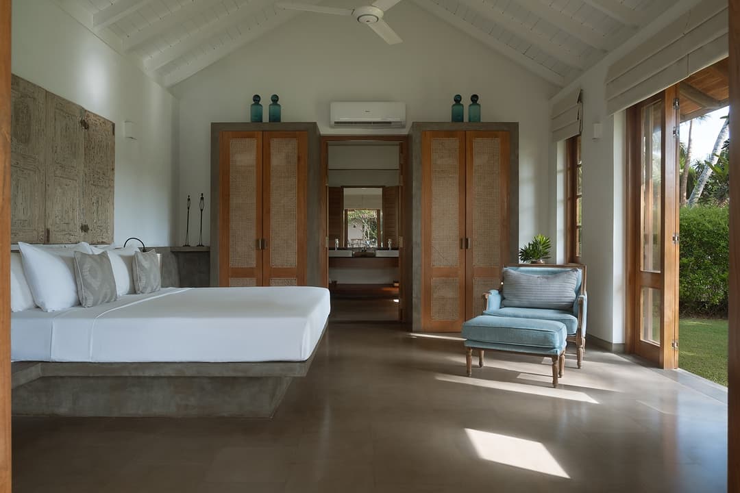 Bedroom with wide garden doors and natural light at Kirana Villa, Bentota, Sri Lanka