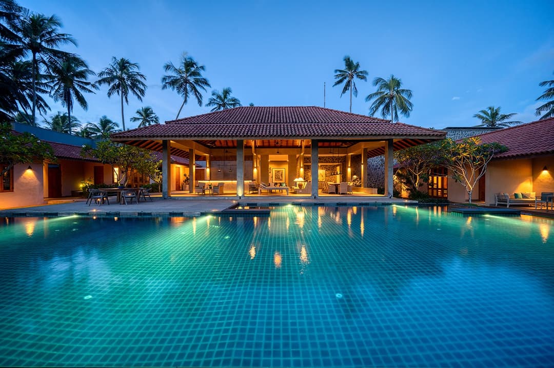 Kirana Villa Bentota exterior and pool illuminated at blue hour dusk, Sri Lanka