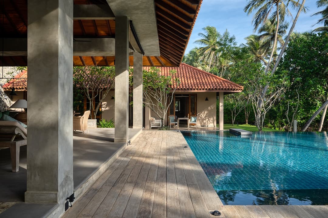 Kirana Villa Bentota pool deck with tropical garden and coconut palms, Sri Lanka