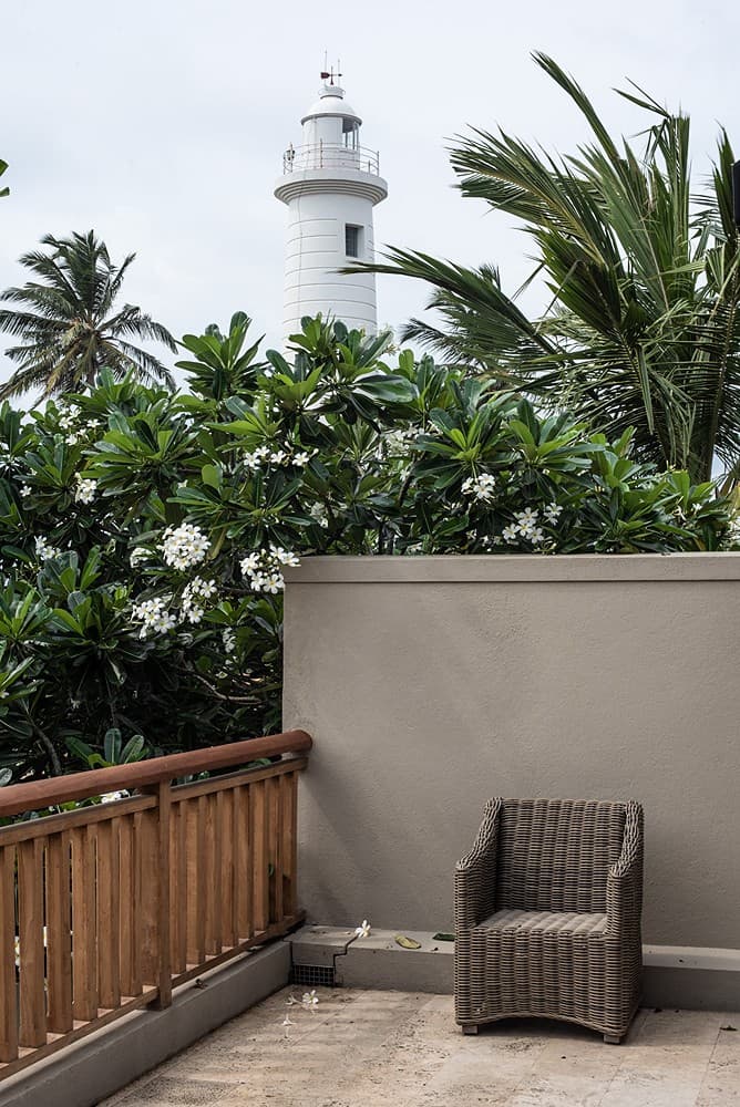 Rooftop terrace with rattan chair and Galle Lighthouse view, No. 77 Leyn Baan, Galle Fort