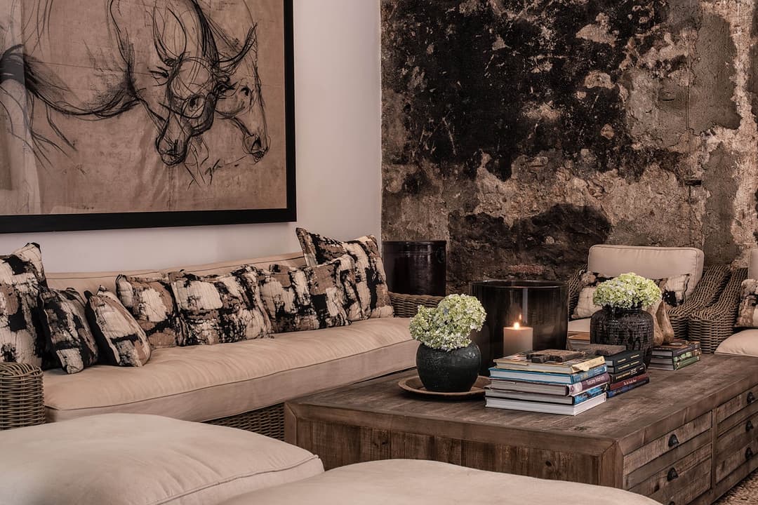 Lounge with raw stone wall and stag deer artwork, No. 77 Leyn Baan, Galle Fort, Sri Lanka