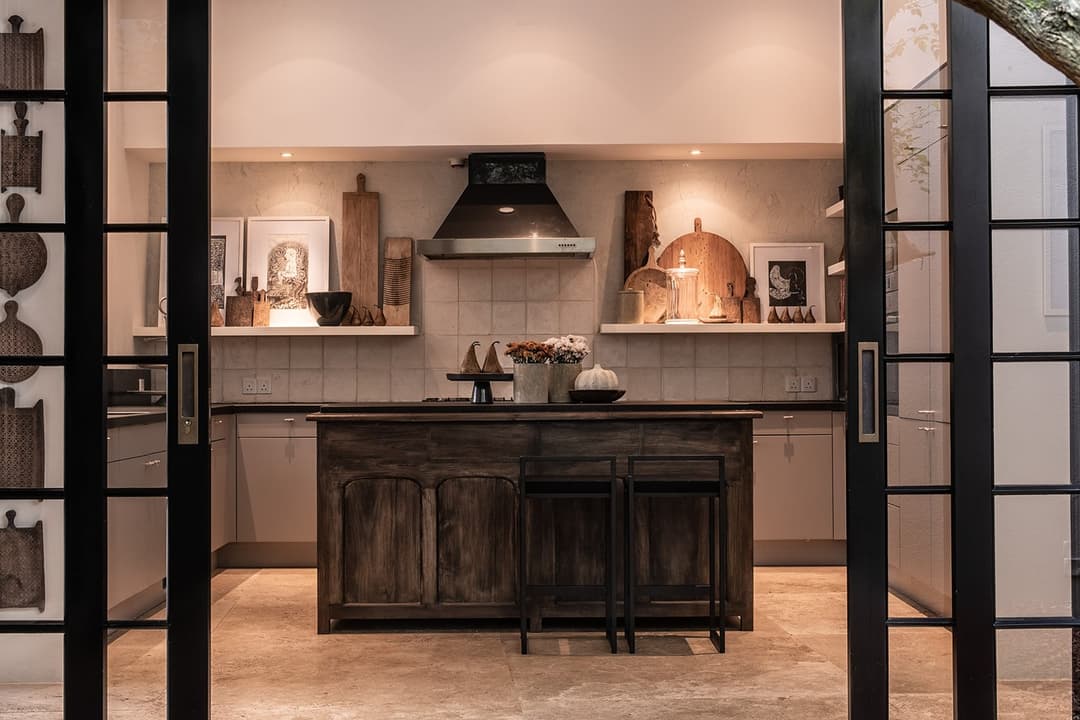 Kitchen with island unit and wood-fired oven beyond, No. 77 Leyn Baan, Galle Fort, Sri Lanka