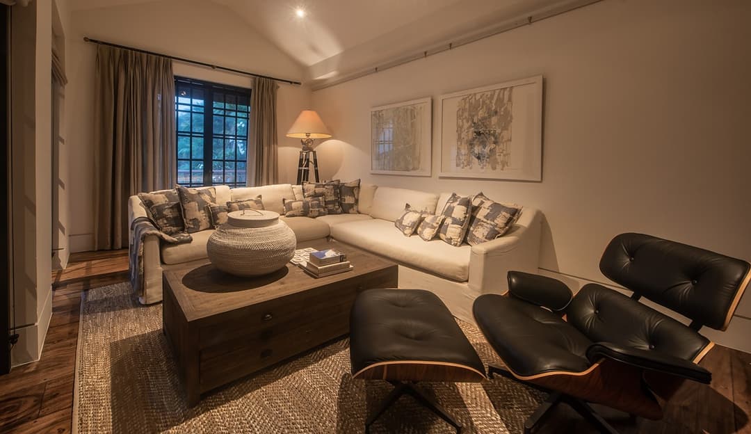 Informal sitting room with sofa and Eames armchair, No. 77 Leyn Baan, Galle Fort, Sri Lanka