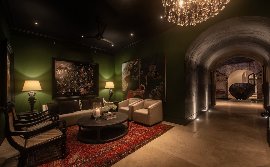 Green lounge with lit painting and chandelier, No. 77 Leyn Baan, Galle Fort, Sri Lanka