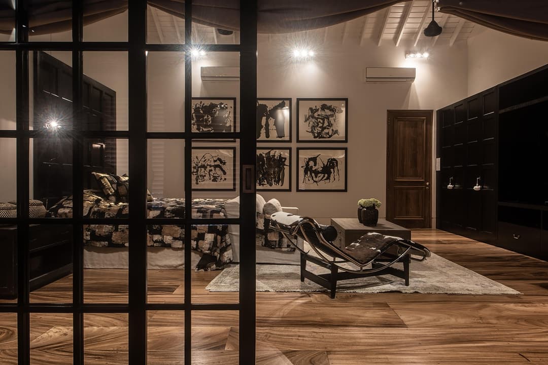 Dark lounge with steel frame glass, chaise and art panels, No. 77 Leyn Baan, Galle Fort