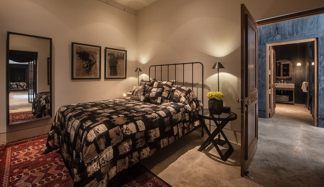 Bedroom with patterned dark bedding and connecting doorway, No. 77 Leyn Baan, Galle Fort
