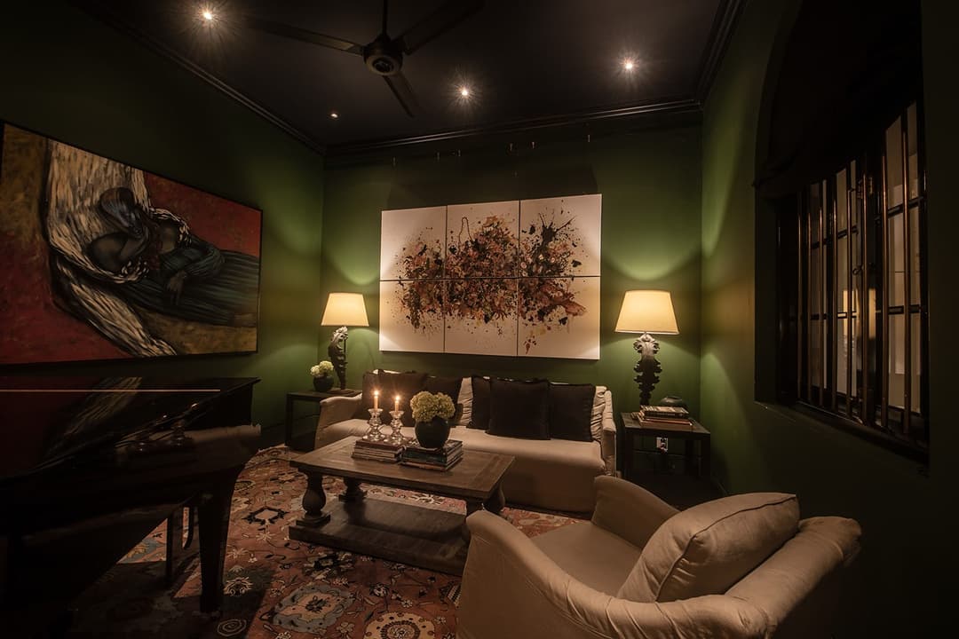Bedroom with dark green headboard and patterned throws, No. 77 Leyn Baan, Galle Fort