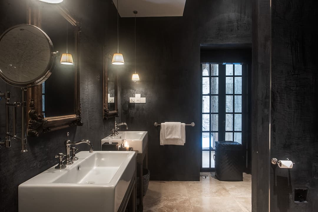 Wide dark bathroom with twin vanity basins and gold mirror, No. 77 Leyn Baan, Galle Fort