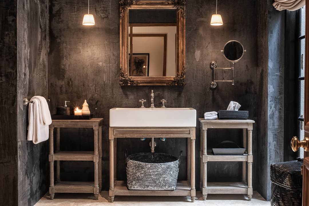 Bathroom with twin stone basins on timber consoles and gold mirrors, No. 77 Leyn Baan Galle