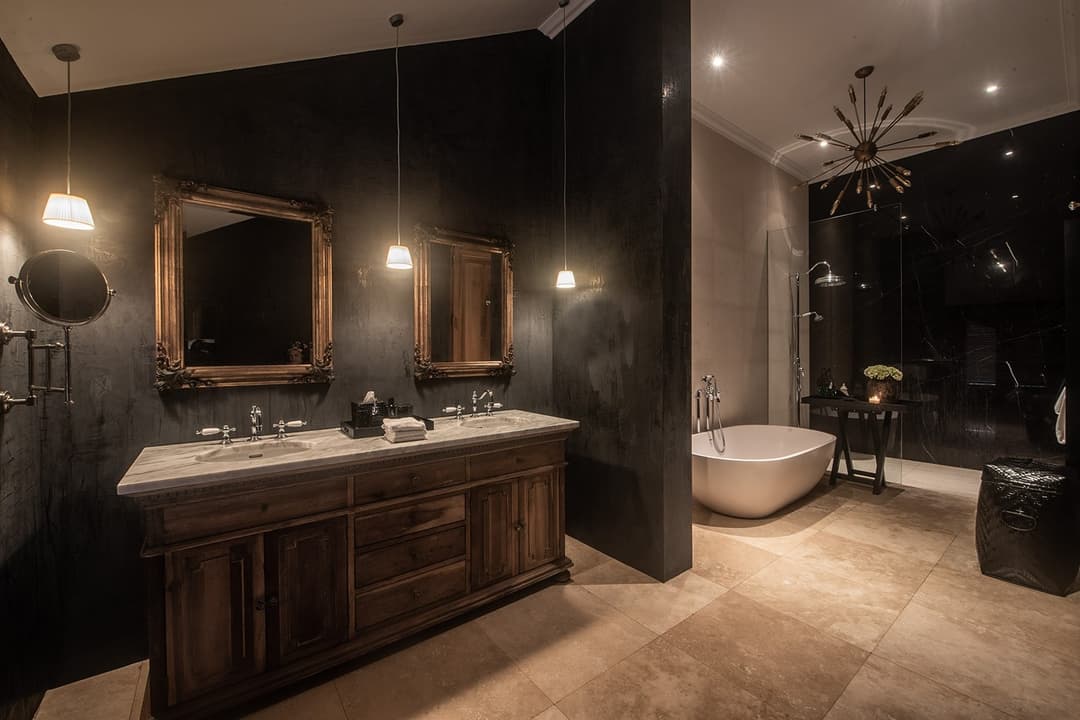 Bathroom with dark wood vanity in warm amber light, No. 77 Leyn Baan, Galle Fort, Sri Lanka