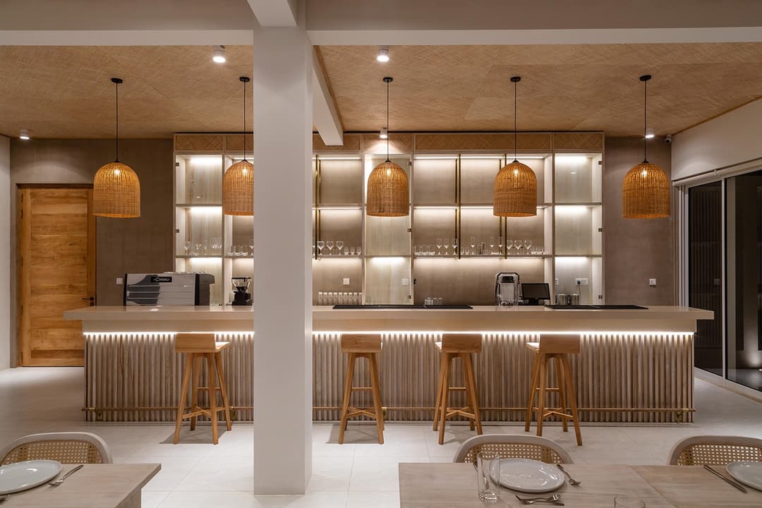 Bar lounge with timber shelving warmly lit at Asaya Sands, Mirissa, Sri Lanka