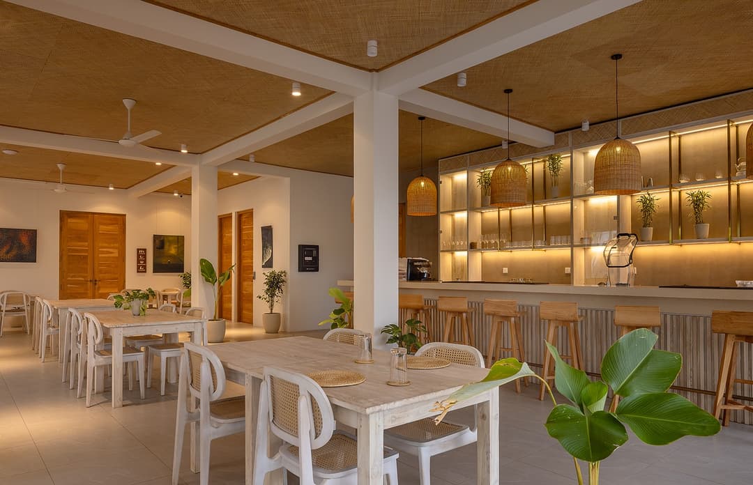 Bar and lounge with timber shelving and pendant lights at Asaya Sands, Mirissa, Sri Lanka