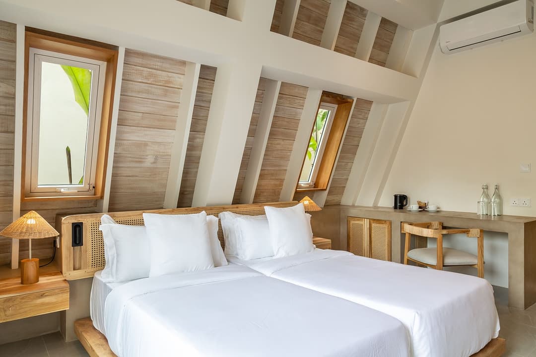 King bedroom with pool view through window at Asaya Sands, Mirissa, Sri Lanka