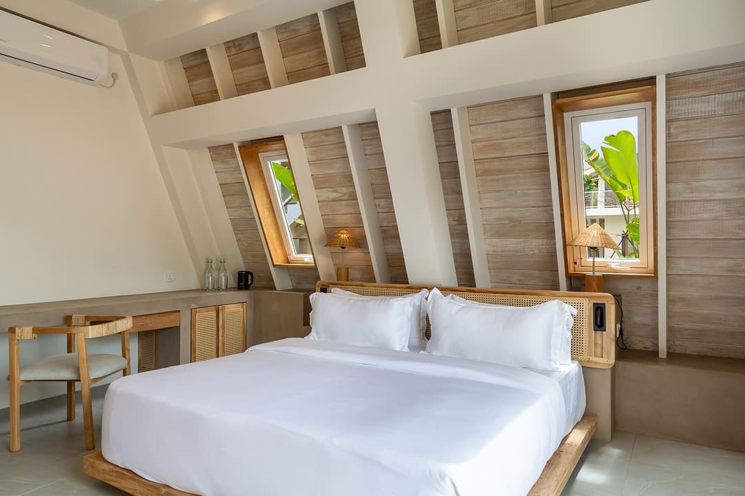 King bedroom with warm tones and vaulted A-frame ceiling at Asaya Sands, Mirissa, Sri Lanka